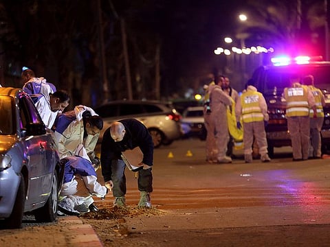Israeli security forces gather at the site of an attack that left two Israeli police dead in the northern city of Hadera on March 27, 2022.