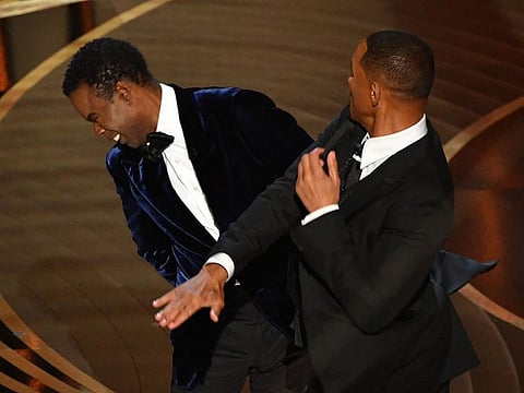 US actor Will Smith (R) slaps US actor Chris Rock at the 94th Oscars at the Dolby Theatre in Hollywood, California, on March 27, 2022.