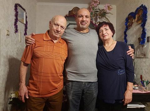 Valerii Gorpenko poses for a picture with his parents in his undated handout.