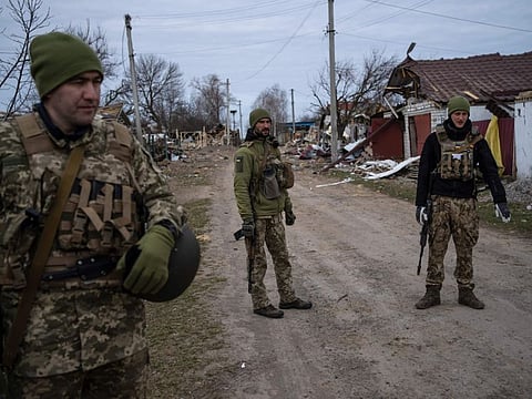 Ukrainian soldiers gather near the front line in Brovary, on the outskirts of Kyiv, Ukraine, Monday, March 28, 2022.