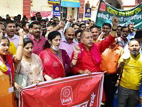 Members of All India Bank Employees Association (AIBEA) shout slogans during a nationwide general strike against the policies of the central government, in Allahabad on March 28, 2022.
