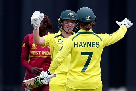 Australia's Alyssa Healy (centre) celebrates reaching her century (100 runs) with teammate Rachael Haynes during the Women's Cricket World Cup semi-final match against the West Indies at the Basin Reserve in Wellington.