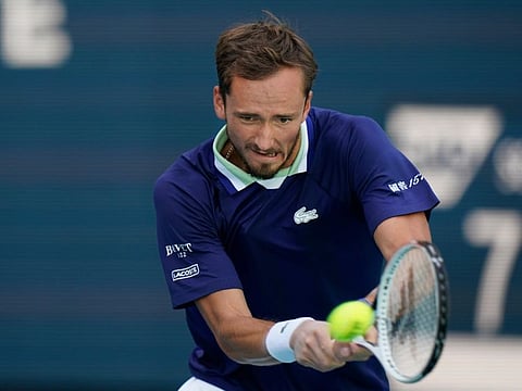Daniil Medvedev of Russia returns a shot from Jenson Brooksby, during the Miami Open tennis tournament in Miami Gardens, Fla.