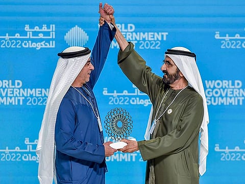 Sheikh Mohammed bin Rashid Al Maktoum (R) presenting an award to Sheikh Saif bin Zayed Al Nahyan at the summit