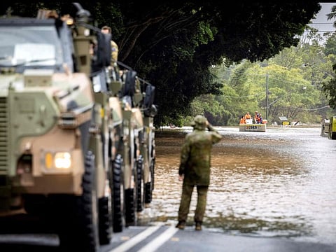 Australian soldiers in Bushmaster protected mobility vehicles are on standby to conduct evacuation tasks with the local State Emergency Services (SES) due to rising flood waters in New South Wales town of Lismore, in support of Operation Flood Assist 2022, on March 30.