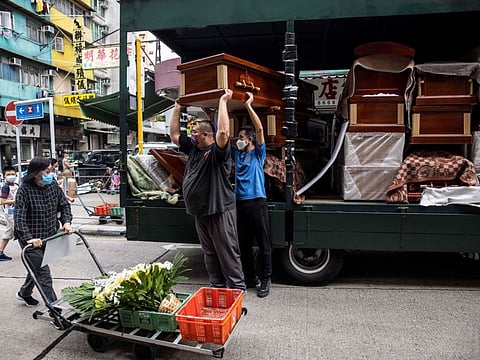 Empty coffins are delivered to a funeral services shop and funeral parlours in the Kowloon district of Hong Kong.