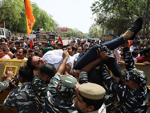 Bharatiya Janata Yuva Morcha (BJYM) supporters scuffle with paramilitary and police personnel during a protest against the statement of Delhi Chief Minister Arvind Kejriwal over the movie 'The Kashmir Files', outside CM residence, in New Delhi on Wednesday.