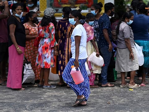 People in a queue to buy kerosene for home use at a service station in Colombo.