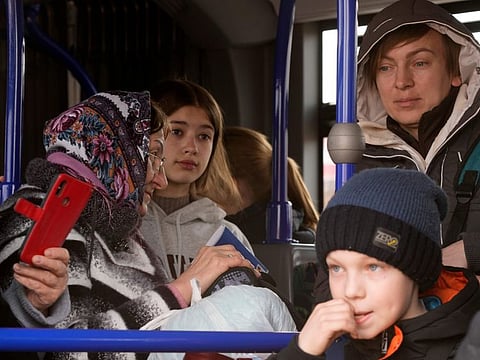 Ukrainian refugees inside a bus after their arrival at border crossing in Medyka, southeastern Poland, on Wednesday, March 30, 2022.