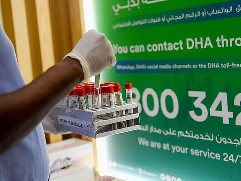 A worker arrange the samples as visitors getting their COVID-19 PCR test done at Dubai Health Authority (DHA) Covid-19 Testing Station at Mall of the Emirates. Photo: Virendra Saklani/Gulf News