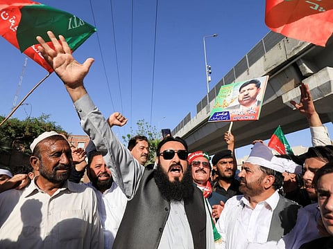 Supporters of the Pakistan Tehreek-e-Insaf (PTI) party chant slogans accusing the US of plotting to overthrow Pakistani Prime Minister Imran Khan, during a protest in Peshawar, Pakistan, April 1, 2022.
