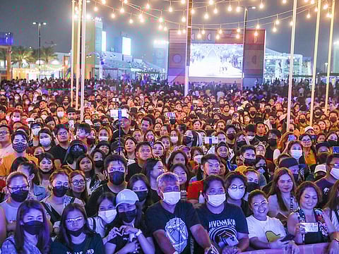 Visitors watch the Expo 2020 Dubai Closing Ceremony at Festival Garden