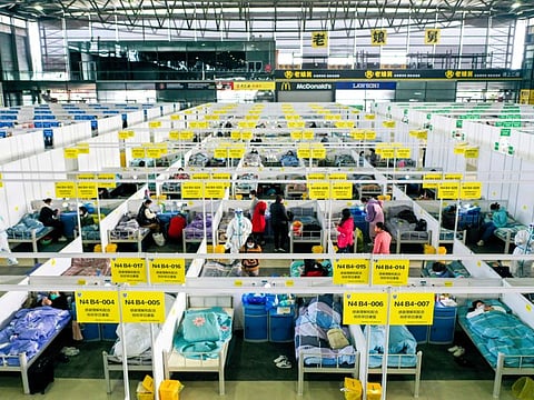 People with mild and symptomatic cases of COVID-19 quarantine at the Shanghai New International Expo Centre in Shanghai, on April 1, 2022.