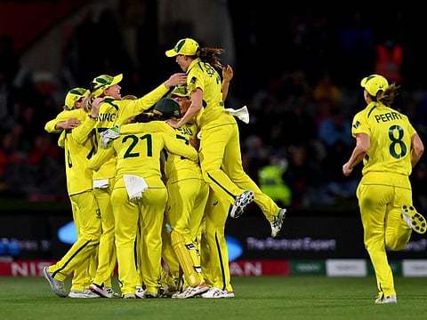 Australia celebrate their win in the 2022 Women's Cricket World Cup final match against England at the Hagley Park Oval in Christchurch.