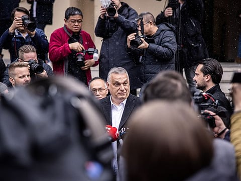 Viktor Orban, Hungary's prime minister, speaks to members of the media after voting at a polling station in Budapest, Hungary, on Sunday, April 3, 2022. Prime Minister Viktor Orbans party was tied with the opposition in a poll published a day before Hungarys election, raising the possibility that the race will be even tighter than previously predicted. Photographer: Akos Stiller/Bloomberg