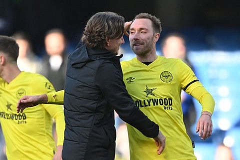 Brentford's Danish midfielder Christian Eriksen (right) is congratulated by Brentford's Danish head coach Thomas Frank after the English Premier League football match against Chelsea at Stamford Bridge in London.