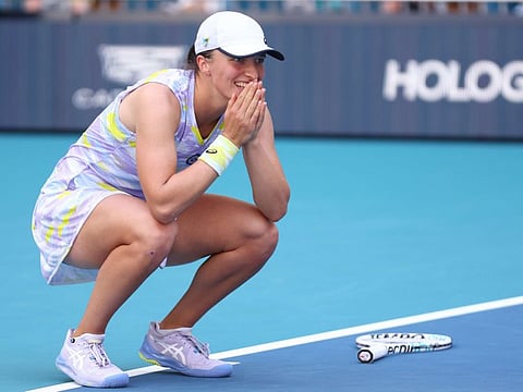 Iga Swiatek of Poland celebrates after beating Naomi Osaka of Japan in the Women's Singles Miami Open final at Hard Rock Stadium in Miami Gardens, Florida.