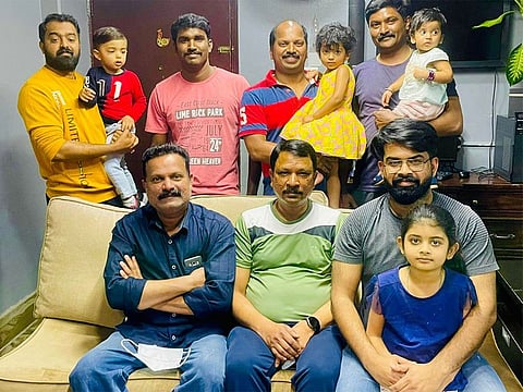 Ratheesh Reghunathan (second from right standing) along with six other colleagues who are among the 12 winners who will share the Dh15million prize.