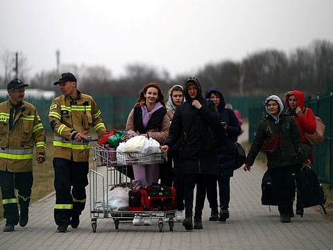 Ukrainian refugees cross the Ukraine-Poland border, amid the Russian war in Ukraine, in Medyka, Poland, March 26, 2022.
