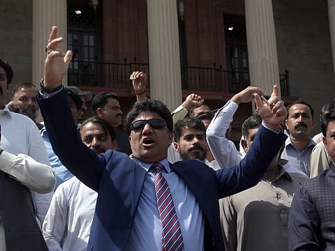 Supporters of the Pakistan Muslim League-Nawaz (PML-N) chant slogans against the ruling government outside the Punjab Assembly building in Lahore, Pakistan April 3, 2022.