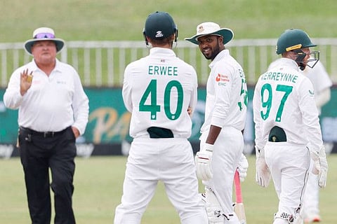 Bangladesh's Ebadot Hossain (second from right) engaged in a banter with South Africa's Sarel Erwee (second from left) during the fifth day of the first Test at Kingsmead stadium in Durban on Monday.