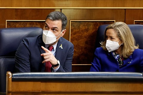 Spanish Prime Minister Pedro Sanchez gestures next to Economy Minister Nadia Calvino ahead of Ukrainian President Volodymyr Zelenskiy appearance on a screen to address members of Spanish parliament via video link, amid Russia's invasion of Ukraine, in Madrid, Spain, April 5, 2022.