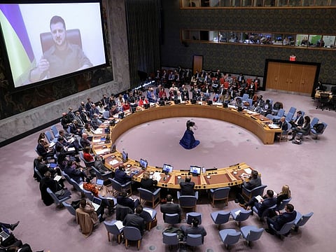 Ukrainian President Volodymyr Zelenskiy appears on a screen as he addresses the United Nations Security Council via video link during a meeting amid Russia's invasion of Ukraine, at the United Nations Headquarters in Manhattan, New York City, New York, U.S., April 5, 2022.