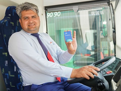 A Dubai Bus driver displays a Loyalty Card. Top-performing bus and taxi drivers in Dubai will be rewarded with special discounts at retail outlets.
