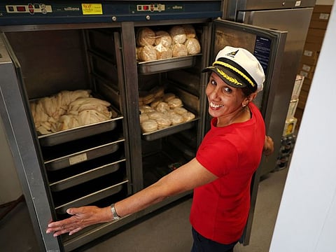 Captain's Fish and Chip shop owner Pam Sandhu, shows the contents of a freezer before opening for business in Brighton on March 25, 2022.