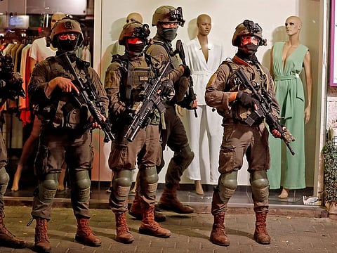 Security forces gather at the scene of a shooting attack in Dizengoff Street in the centre of Israel's Mediterranean coastal city of Tel Aviv on April 7, 2022.