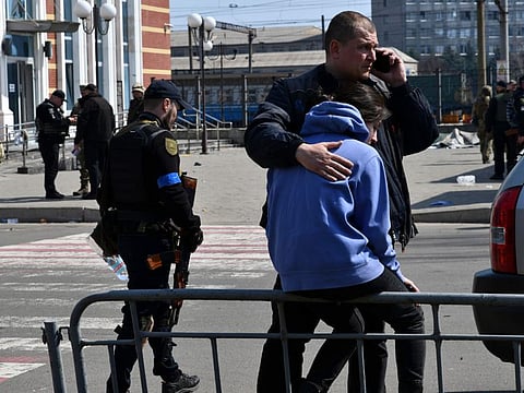 A man hugs a woman after Russian shelling at the railway station in Kramatorsk, Ukraine, Friday, April 8, 2022.