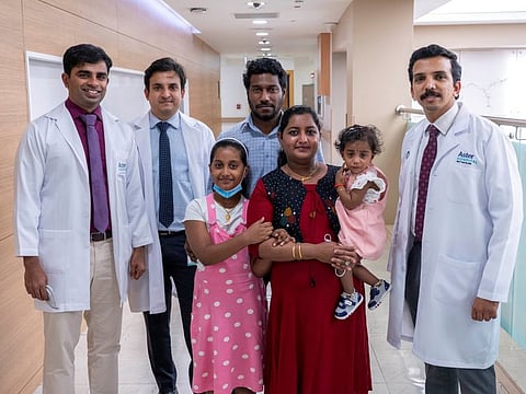 Baby Akshara - now one and a half years old - with her parents, siblings and doctors