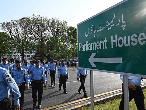 Police officers arrive to deploy outside the Pakistan Parliament House building in Islamabad on April 9, 2022.