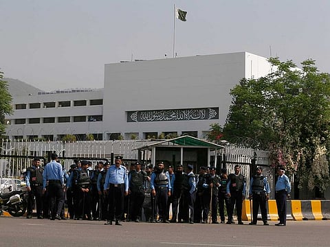 Police officers stand guard to ensure security outside the National Assembly, in Islamabad, Pakistan, Saturday, April 9, 2022.