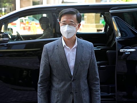 Former Hong Kong Chief Secretary John Lee, arrives at an office building where he has temporary office in preparation for running the upcoming leadership race in Hong Kong, Friday, April 8, 2022.