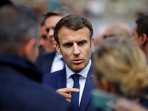 French President Emmanuel Macron, candidate for his re-election in the 2022 French presidential election, speaks with supporters during a campaign trip in Spezet, France, April 5, 2022.