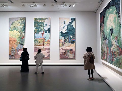 In this file photo taken on September 15, 2021, a woman looks at paintings by French painter Pierre Bonnard during a press visit of the exhibition "The Morozov Collection - Modern art icons" at the Fondation Louis Vuitton in Paris.