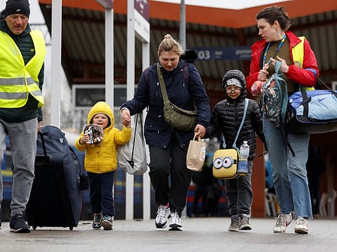 Ukrainian refugees fleeing the Russia's invasion of Ukraine walk on the platform after arriving on a train from Odesa at Przemysl Glowny train station, in Poland, April 9, 2022. REUTERS/Leonhard Foeger
