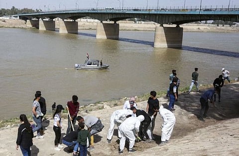 Young Iraqi volunteers take part in a clean-up campaign on the bank of the Tigris river in the Adhamiyah district of the capital Baghdad.