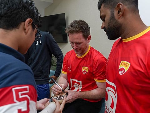 England skipper Eoin Morgan signs autograph to budding cricketers during a interaction with the budding players.