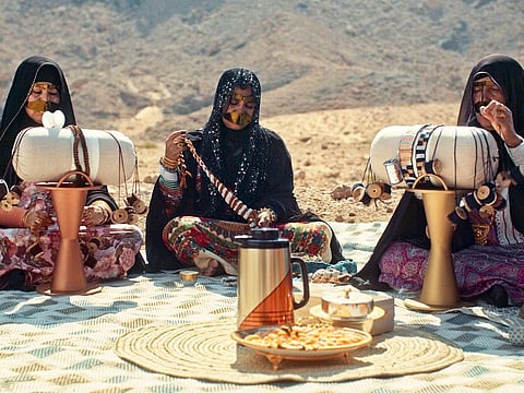 Emirati artisans create fashionable lace using the craft of talli on a cylindrical pillow, supported by a conical metal stand.
