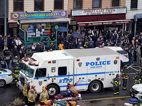 Emergency personnel gather at the entrance to a subway stop in the Brooklyn borough of New York, on April 12, 2022.