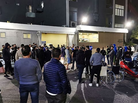 Men gather outside a hospital where some injured people are believed to be transferred to, after an explosion, near Sidon in southern Lebanon April 12, 2022.