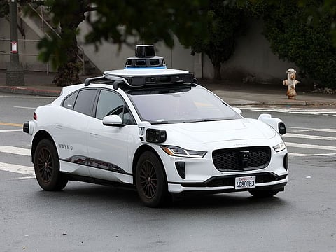 An autonomous vehicle drives along Masonic Avenue in San Francisco, California.