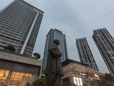 A statue of former Sri Lanka Prime Minister S. W. R. D. Bandaranaike in front of buildings in Colombo, Sri Lanka.