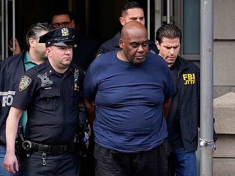 New York City Police and law enforcement officials lead subway shooting suspect Frank R. James, 62, center, away from a police station, in New York, Wednesday, April 13, 2022.