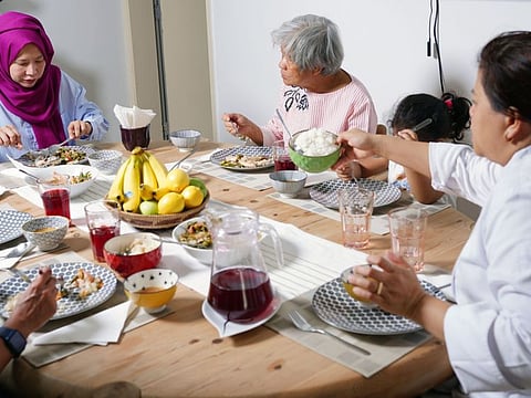 The family of Iman Suguitan enjoys an Iftar meal prepared at home.