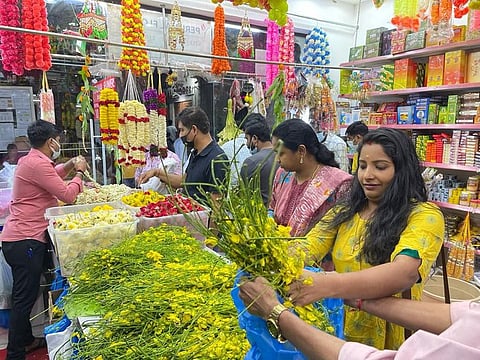 Indian expats from Kerala buying the Konna flowers which is traditionally used for Vishu celebrations.