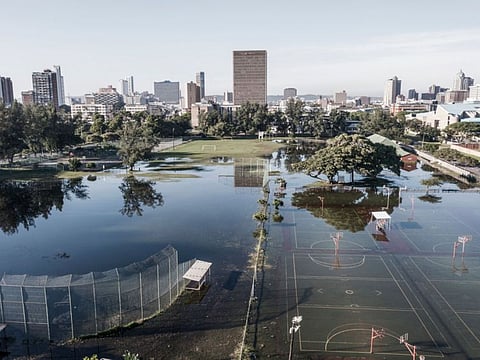This aerial view shows sports fields under water days after heavy rains in Durban on April 15, 2022.