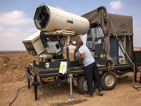 An Israeli police officer demonstrates a laser defence system designed to intercept explosives-laden balloons launched from the Gaza Strip into Israel, on the Israeli Gaza border, in a file photo.